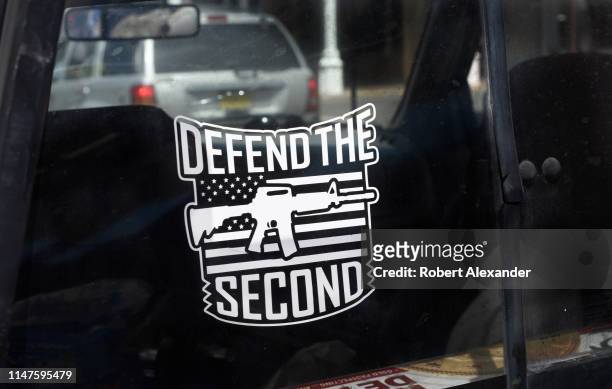 An assault rifle decal on a gun rights advocate's pickup truck urges the defense of the U.S. Constitution's Second Amendment.