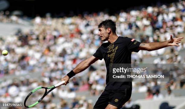 Argentina's Juan Ignacio Londero plays a backhand return to Spain's Rafael Nadal during their men's singles fourth round match on day eight of The...