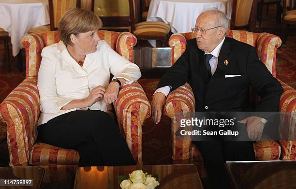 German Chancellor Angela Merkel chats with Tunisian Prime Minister Beji Caid Essebsi during a bilateral meeting at the G8 Summit on May 26, 2011 in...