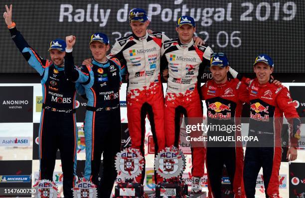 Toyota's Estonian driver Ott Tanak and Estonian co-driver Martin Jarveoja celebrate after winning the 2019 Rally of Portugal ahead of Hyundai's...