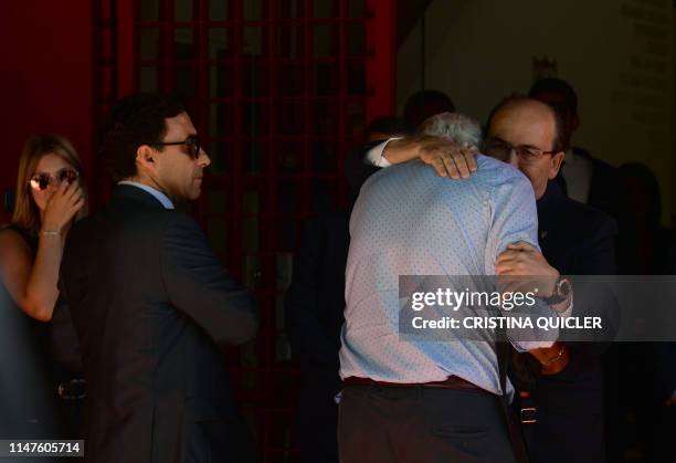 Sevilla FC president Jose Castro embraces the father of Spanish football player Jose Antonio Reyes during the wake for the footballer at the Ramon...