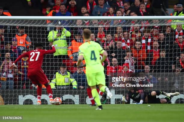 Divock Origi scores his team's first goal during the UEFA Champions League Semi Final second leg match between Liverpool and Barcelona at Anfield on...