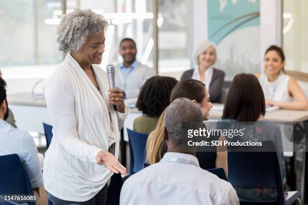 mature african american woman introduces husband - casual panel discussion stock pictures, royalty-free photos & images