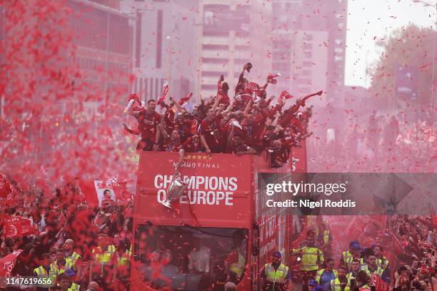 Liverpool's players with the UEFA Champions League trophy on board a parade bus after winning the UEFA Champions League final against Tottenham...