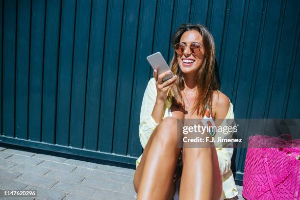 woman with summer clothes using mobile phone - cell phone using beach stock pictures, royalty-free photos & images