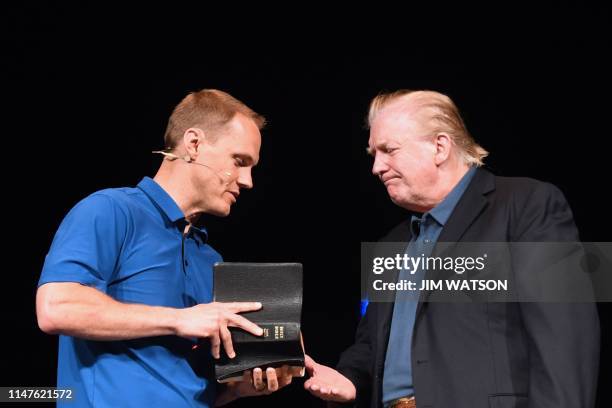 President Donald Trump shakes hands with Pastor David Platt as he visits McLean Bible Church in Vienna, Virginia on June 2 to pray for the victims...