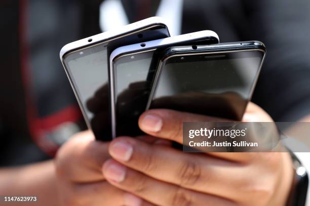 An attendee holds a stack of the new Google Pixel 3a during the 2019 Google I/O conference at Shoreline Amphitheatre on May 07, 2019 in Mountain...