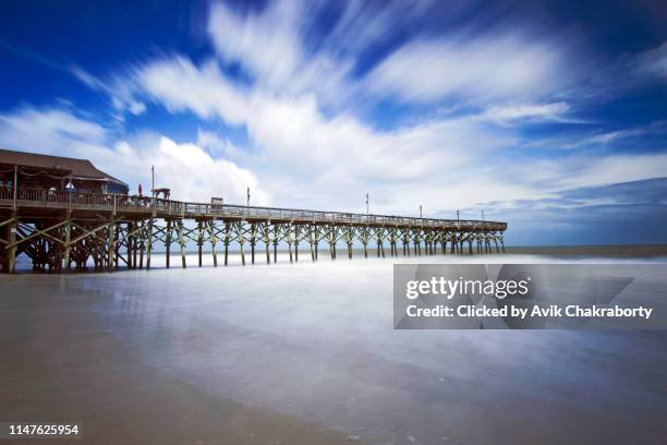 moving clouds over boardwalk in myrtle beach, south carolina, usa - myrtle beach stock pictures, royalty-free photos & images