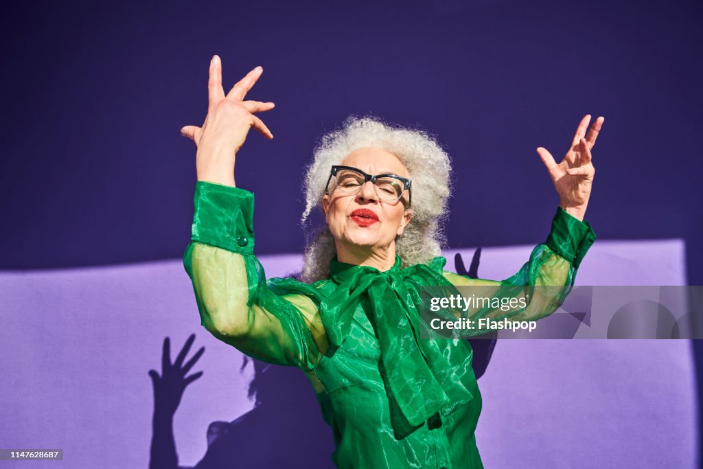 Colourful studio portrait of a senior woman