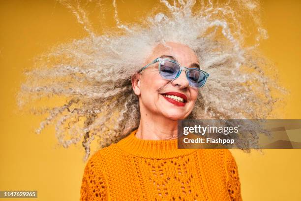 colourful studio portrait of a senior woman - beautiful mature woman stock pictures, royalty-free photos & images