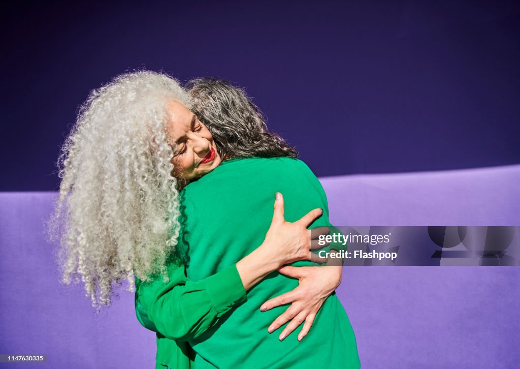 Colourful studio portrait of a senior man and woman