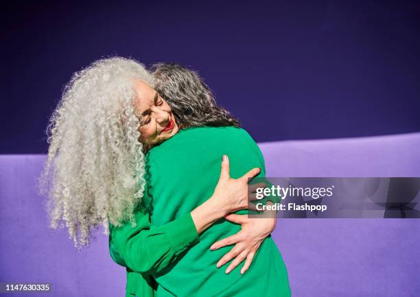 colourful studio portrait of a senior man and woman - rapport photos et images de collection