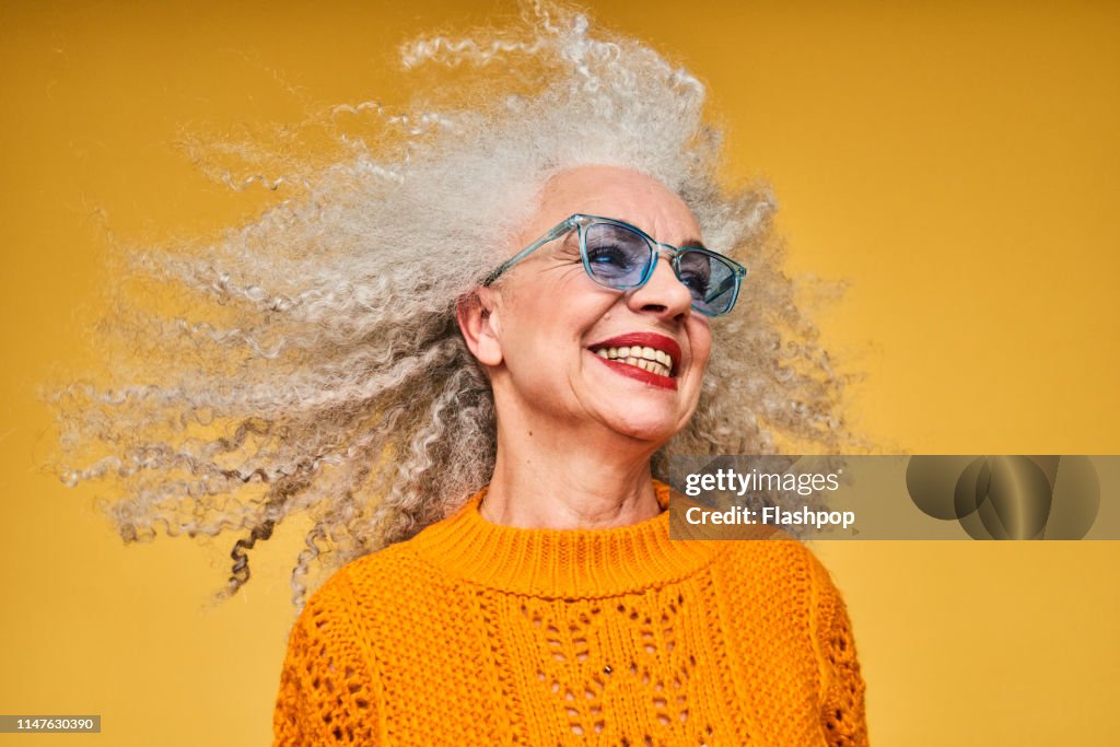 Colourful studio portrait of a senior woman