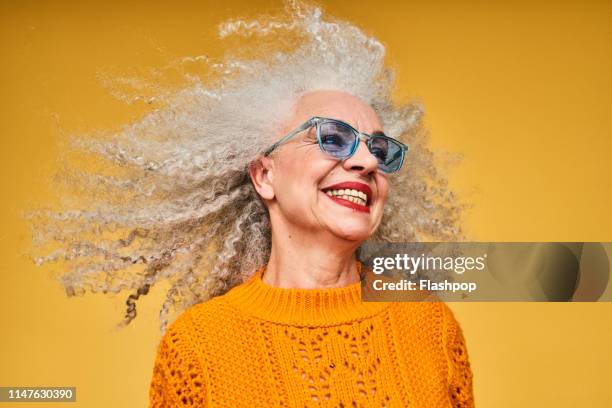 colourful studio portrait of a senior woman - glasses woman stockfoto's en -beelden