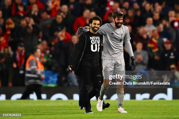 Mohamed Salah of Liverpool and teammate Alisson celebrate after the UEFA Champions League Semi Final second leg match between Liverpool and Barcelona...