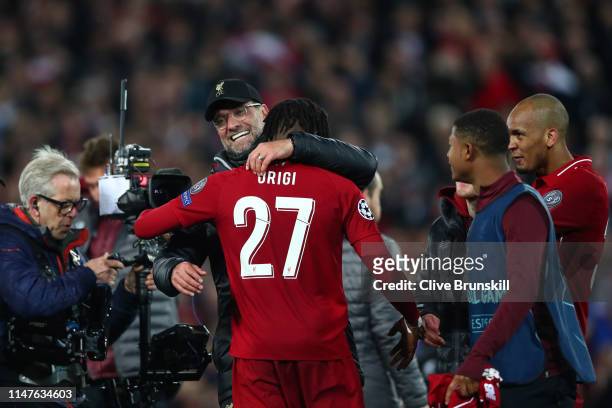 Jurgen Klopp, Manager of Liverpool and Divock Origi celebrate after the UEFA Champions League Semi Final second leg match between Liverpool and...