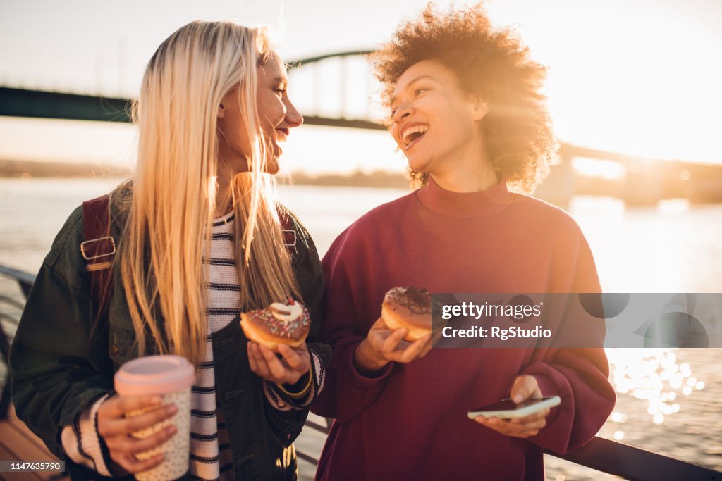 Girls eating donuts and smiling