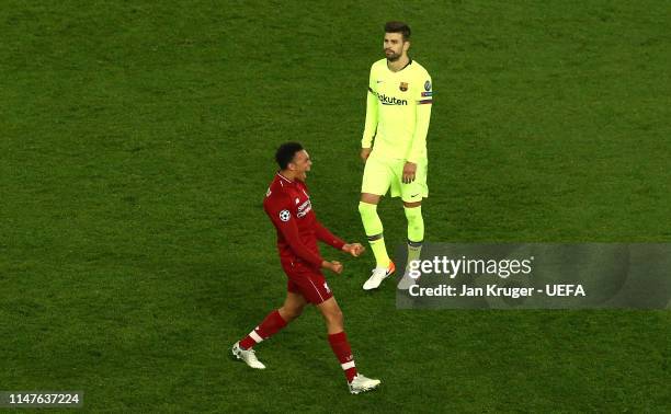 Trent Alexander-Arnold of Liverpool celebrates at the final whistle with Gerard Pique of Barcelona looking on during the UEFA Champions League Semi...