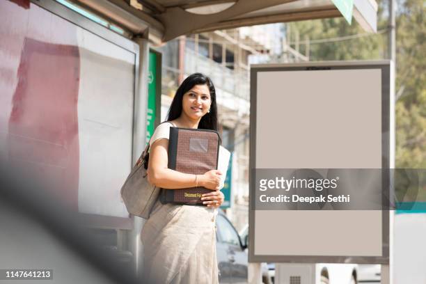 businesswoman waiting for the transport - bus shelter stock pictures, royalty-free photos & images