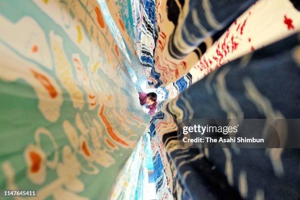 Worker dries tenugui, Japanese cotton towel as its production is full swing on May 7, 2019 in Sakai, Osaka, Japan.