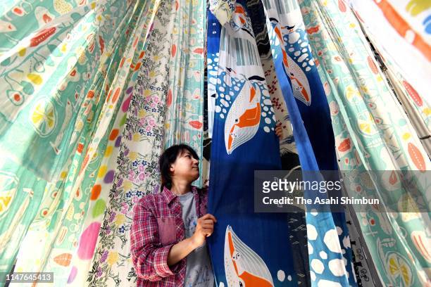 Worker dries tenugui, Japanese cotton towel as its production is full swing on May 7, 2019 in Sakai, Osaka, Japan.