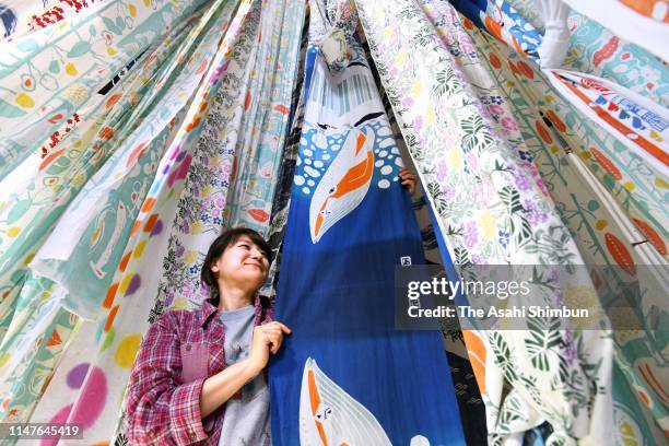 Worker dries tenugui, Japanese cotton towel as its production is full swing on May 7, 2019 in Sakai, Osaka, Japan.