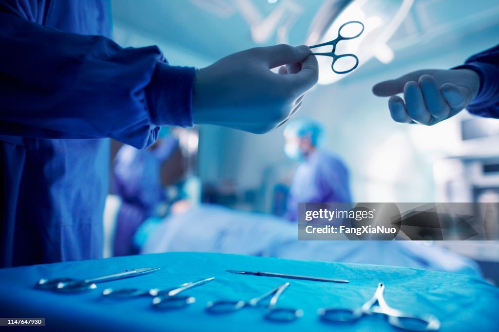 Doctor Operating Tools Handing Doctor Surgical Tool In Operating Room High-Res Stock Photo ...