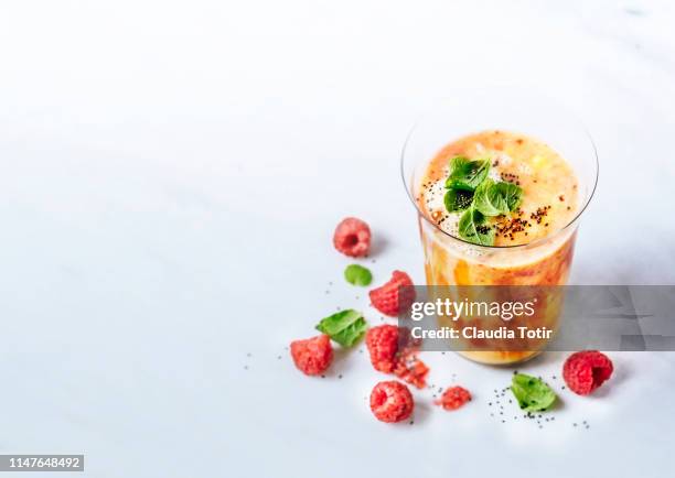 raspberry and mango smoothie - blended drink stock pictures, royalty-free photos & images