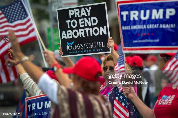 Woman holds an anti-abortion placard as supporters of President Donald Trump rally outside the Wilshire Federal Building on June 2, 2019 in Los...