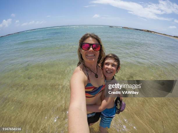 playful, fun selfies with mom in a tropical ocean - mourning parents stock pictures, royalty-free photos & images