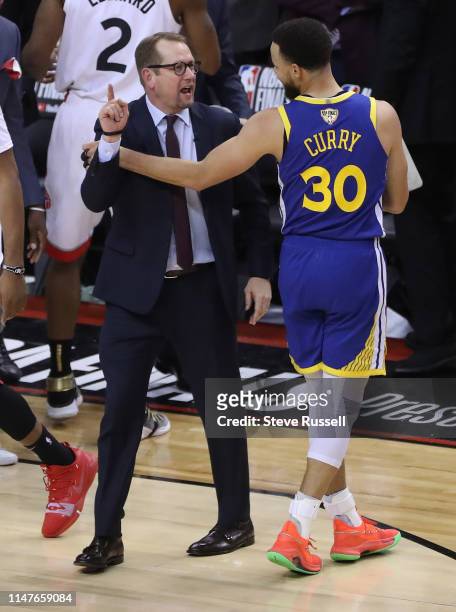 Toronto Raptors head coach Nick Nurse says something to Golden State Warriors guard Stephen Curry as time runs down as the Toronto Raptors play the...