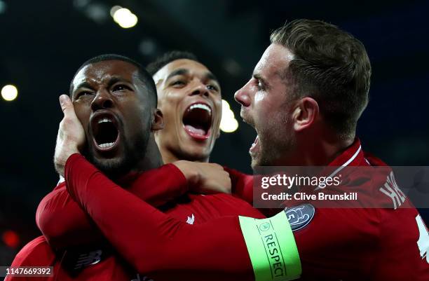 Georginio Wijnaldum of Liverpool celebrates after scoring his team's third goal with Jordan Henderson and Trent Alexander-Arnold during the UEFA...