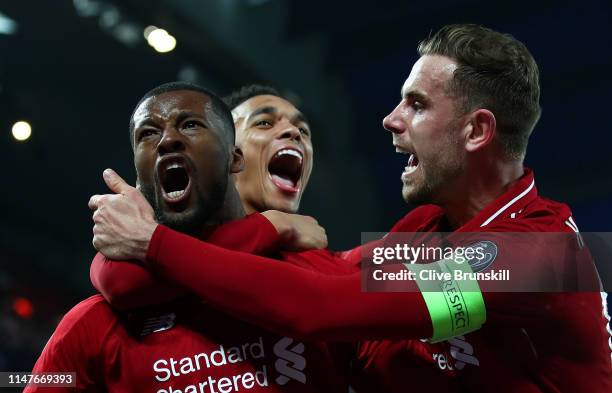 Georginio Wijnaldum of Liverpool celebrates after scoring his team's third goal with Jordan Henderson and Trent Alexander-Arnold during the UEFA...