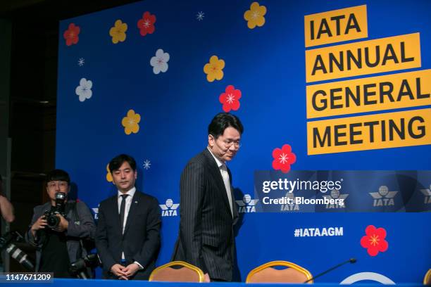 Walter Cho, president of Korean Air Lines Co., right, arrives for a news conference at the International Air Transport Association annual general...