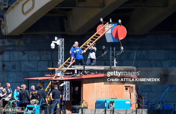 Workers build a ladder as rescue efforts are under way on Danube river in Budapest on June 3, 2019 to check the position of the sunk Hungarian...
