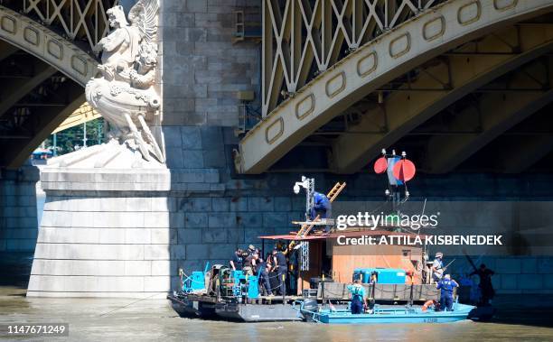 Workers build a ladder as rescue efforts are under way on Danube river in Budapest on June 3, 2019 to check the position of the sunk Hungarian...
