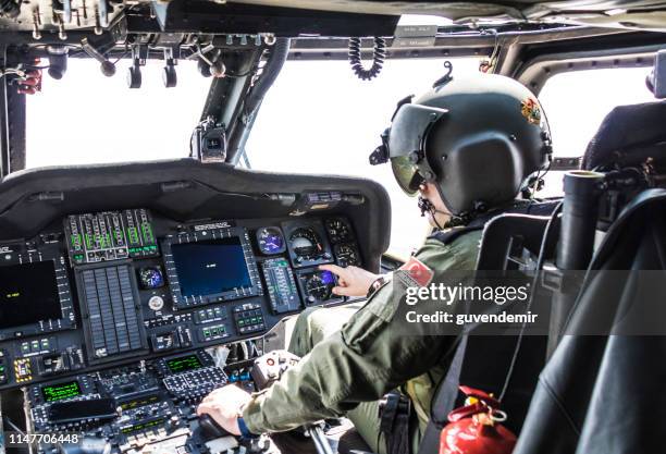 turkish army pilot riding military helicopter - helicopter pilot stock pictures, royalty-free photos & images