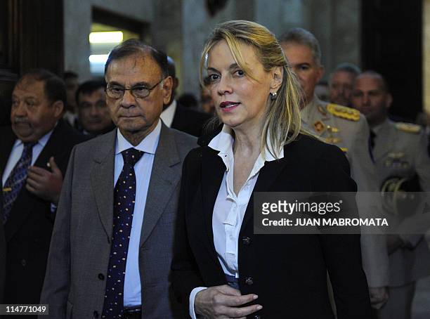 The UNASUR General Secretary, Maria Emma Mejia of Colombia, walks next to Venezuela's Electricity Minister Ali Rodriguez, upon arrival at the...