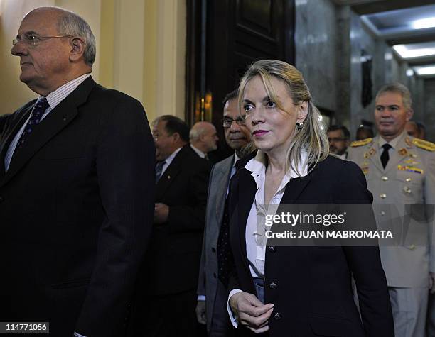 The UNASUR General Secretary, Maria Emma Mejia of Colombia, walks next to Brazil's Defense Minister Nelson Jobim, upon arrival at the Argentine...