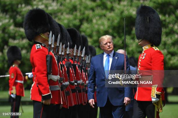 President Donald Trump inspects an honour guard during a welcome ceremony at Buckingham Palace in central London on June 3 on the first day of their...