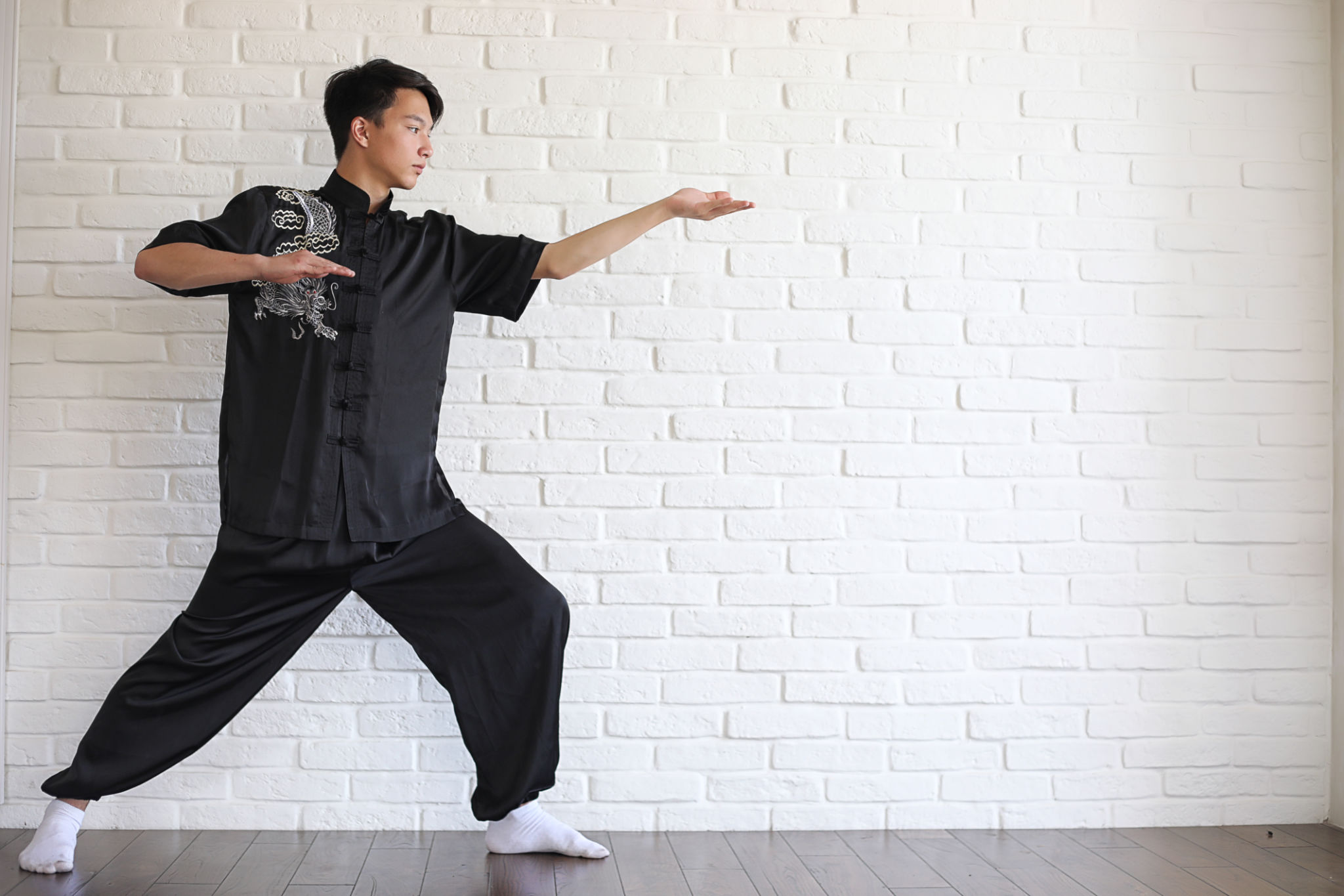 Asian young novice on a white brick wall Asian young novice on a white brick wall