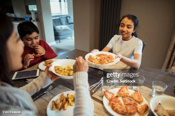 pizza is my favourite! - teenagers eating with mum stock pictures, royalty-free photos & images