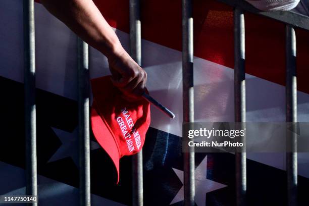 Fan hold out a MAGA caps and sharpies as US President Donald J. Trump departs after speaking at a MAGA rally at the Williamsport Regional Airport, in...