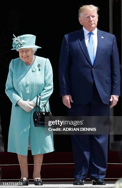 President Donald Trump stands with Britain's Queen Elizabeth II during a welcome ceremony at Buckingham Palace in central London on June 3 on the...