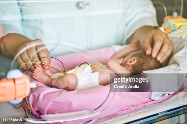 Infant in an incubator in the maternity ward of a hospital.