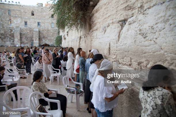 The Western Wall in the Jewish quarter of the Old City. Here, the area reserved for women. Woman praying on a Friday evening of Shabbat.