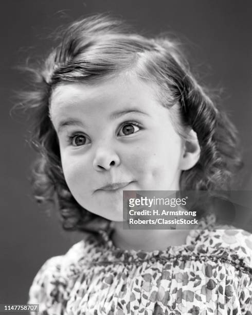 1930s 1940s PORTRAIT BRIGHT WIDE-EYED FUNNY CUTE LITTLE GIRL LOOKING AT CAMERA SURPRISED AMAZED FACIAL EXPRESSION OF WONDER
