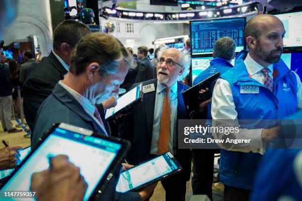 Traders and financial professionals work at the opening bell on the floor of the New York Stock Exchange , June 3, 2019 in New York City. Stocks...