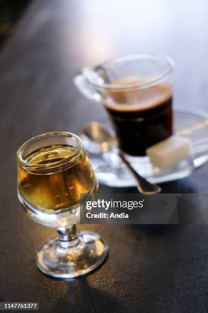 Coffee and Calvados on a bar counter.