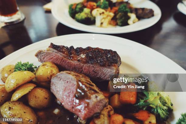 freshly served traditional icelandic food: roasted lamb steak served with grilled vegetables and potatoes - アイスランド文化 ストックフォトと画像